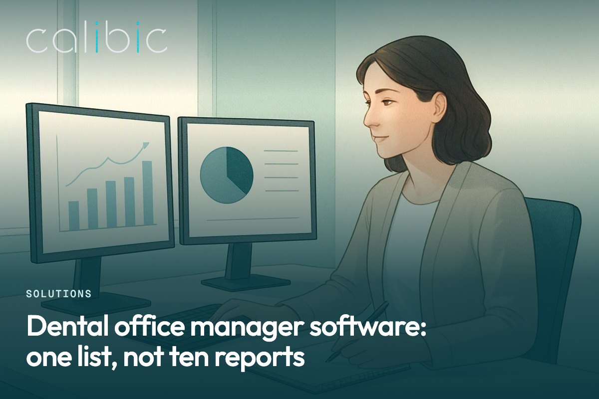An office manager at a desk with two monitors and a notepad